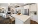 Open-concept kitchen with white cabinets, stainless steel appliances, and large island with seating at 3730 Ashford Ne Pt, Brookhaven, GA 30319