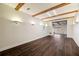 Spacious living room featuring hardwood floors, wood beam ceilings, and recessed lighting at 3730 Ashford Ne Pt, Brookhaven, GA 30319