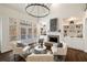 Sunlit living area with built-in shelving, a cozy fireplace, and comfortable seating arrangement at 3730 Ashford Ne Pt, Brookhaven, GA 30319