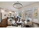 Inviting living room featuring a modern chandelier, natural light, and an open layout with views of the kitchen and deck at 3730 Ashford Ne Pt, Brookhaven, GA 30319