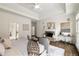 Beautiful main bedroom features a stone fireplace, sitting area, trey ceiling, and a view to the ensuite bath at 3730 Ashford Ne Pt, Brookhaven, GA 30319