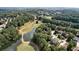 High aerial view of the community featuring lush greenery, a lake, and golf course, showcasing the serene environment at 6455 Rutherford Pl, Suwanee, GA 30024