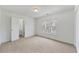 Bright bedroom featuring neutral carpet, a window, and a closet for ample storage at 6455 Rutherford Pl, Suwanee, GA 30024