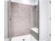 Walk-in shower with gray mosaic tile, built-in seat, and glass enclosure at 775 Juniper Ne St # 327, Atlanta, GA 30308