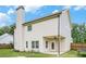 Backyard view showcasing the home's siding, chimney, and covered patio at 61 Harmony Woods Ln, Dallas, GA 30157