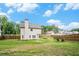 Wide shot of the backyard showing grassy area, privacy fence and the home's exterior at 61 Harmony Woods Ln, Dallas, GA 30157