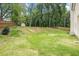 Expansive grassy backyard with a slight slope, wooden fence, and some trees at 61 Harmony Woods Ln, Dallas, GA 30157