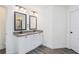 Bathroom showcasing double sinks, granite counters, framed mirrors, and white cabinets at 61 Harmony Woods Ln, Dallas, GA 30157