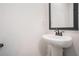 Bathroom featuring a pedestal sink and a framed mirror at 61 Harmony Woods Ln, Dallas, GA 30157