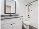 Bright bathroom with a shower-tub combo, granite countertop, and white cabinets at 61 Harmony Woods Ln, Dallas, GA 30157