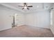 Large primary bedroom with tray ceiling, carpet flooring, and ensuite bathroom access at 61 Harmony Woods Ln, Dallas, GA 30157