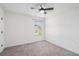 Bright bedroom with neutral carpet, ceiling fan, and a window at 61 Harmony Woods Ln, Dallas, GA 30157