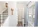 Bright entryway with stairs, half bath, and wood-look floors at 61 Harmony Woods Ln, Dallas, GA 30157