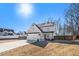 Two-story house with gray siding, a large driveway, and a fenced backyard at 61 Harmony Woods Ln, Dallas, GA 30157