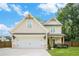 Charming two-story home with a two-car garage, a manicured lawn, and craftsman architectural details at 61 Harmony Woods Ln, Dallas, GA 30157
