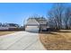 Two-story house with gray siding, a large driveway, and a fenced backyard at 61 Harmony Woods Ln, Dallas, GA 30157