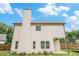 Two-story home showcasing the siding, roof, and backyard with blue skies overhead at 61 Harmony Woods Ln, Dallas, GA 30157
