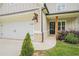 Well-maintained home featuring a black front door, brick accents, and dark exterior lighting fixtures at 61 Harmony Woods Ln, Dallas, GA 30157