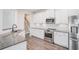 Modern kitchen featuring granite countertops, stainless steel appliances, subway tile backsplash, and white cabinets at 61 Harmony Woods Ln, Dallas, GA 30157