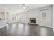 Spacious living room with wood-look floors, stone fireplace, and ample natural light from the large windows at 61 Harmony Woods Ln, Dallas, GA 30157