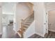 Inviting home entryway featuring wood-look floors, wood stairs with black iron railings, and an open-concept layout at 61 Harmony Woods Ln, Dallas, GA 30157