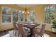 Dining room with hardwood floors, chandelier, and wooded views at 3091 Old Mill Road, Rutledge, GA 30663