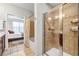 Bathroom with a glass-enclosed shower, tile surround, and a view into the bedroom at 401 16Th Nw St # 1376, Atlanta, GA 30363