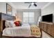 Relaxing bedroom features a ceiling fan, plush bedding, and natural light at 401 16Th Nw St # 1376, Atlanta, GA 30363
