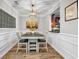 Elegant dining room with wainscoting and a view of the kitchen, featuring modern lighting and neutral decor at 401 16Th Nw St # 1376, Atlanta, GA 30363