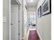 Bright hallway features a red rug and leads to a bedroom with a view of the outside at 401 16Th Nw St # 1376, Atlanta, GA 30363