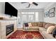 Comfortable living room with a fireplace, large sofa, and access to a balcony, bathed in natural light at 401 16Th Nw St # 1376, Atlanta, GA 30363