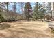 Spacious backyard features a stone fire pit and a stone path, great for outdoor activities at 4478 Outpost Ct, Roswell, GA 30075