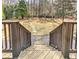 Staircase leads to a large backyard with a stone path and a stone firepit at 4478 Outpost Ct, Roswell, GA 30075