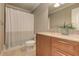 Bright bathroom featuring a shower-tub, a single sink, and a granite countertop, providing a clean and inviting space at 4478 Outpost Ct, Roswell, GA 30075