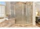 Elegant bathroom with large glass enclosed shower, travertine tile, and views to bedroom at 4478 Outpost Ct, Roswell, GA 30075