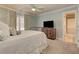 Bedroom with soft blue walls, bright natural light, and a vintage-style bedframe, exuding a comforting vibe at 4478 Outpost Ct, Roswell, GA 30075