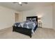 Bedroom with neutral carpet and a dark bedframe paired with matching side table, creating a cozy atmosphere at 4478 Outpost Ct, Roswell, GA 30075
