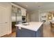 Large kitchen island with stainless steel refrigerator and sink at 4478 Outpost Ct, Roswell, GA 30075