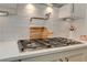 Modern kitchen features a pot filler over a stainless steel gas cooktop with white subway tile backsplash at 4478 Outpost Ct, Roswell, GA 30075
