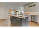 Spacious kitchen featuring an island with a sink, stainless steel appliances, and hardwood floors at 4478 Outpost Ct, Roswell, GA 30075