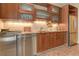 Close-up of kitchenette with stainless steel appliances and wood cabinetry showcasing both style and functionality at 4478 Outpost Ct, Roswell, GA 30075
