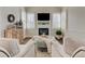 Living room featuring comfortable seating, fireplace and mantel, and windows with shutters at 4478 Outpost Ct, Roswell, GA 30075
