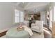 Comfortable living room featuring two armchairs and an ottoman with views into the gourmet kitchen at 4478 Outpost Ct, Roswell, GA 30075