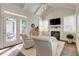 Living room showcasing French doors, hardwood floors, vaulted ceilings, and a cozy fireplace at 4478 Outpost Ct, Roswell, GA 30075