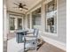 Covered porch with ceiling fan, table and chairs with an adjacent door to the house at 4478 Outpost Ct, Roswell, GA 30075