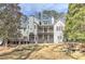 Lovely rear exterior with two-story deck overlooking a beautifully landscaped yard with mature trees at 4478 Outpost Ct, Roswell, GA 30075