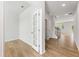 Bright entryway showcasing hardwood floors, white trim, and a glass door leading to a study at 5539 Rosehall Pl, Atlanta, GA 30349