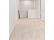 Upstairs hallway featuring neutral colored carpet and white walls at 5539 Rosehall Pl, Atlanta, GA 30349