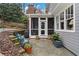 Stone patio adjacent to house, featuring potted plants and a grill at 927 Amsterdam Ne Ave, Atlanta, GA 30306