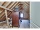 Unfinished attic space with exposed beams, offering potential for customization and additional storage at 305 Glengarry Chase, Covington, GA 30014